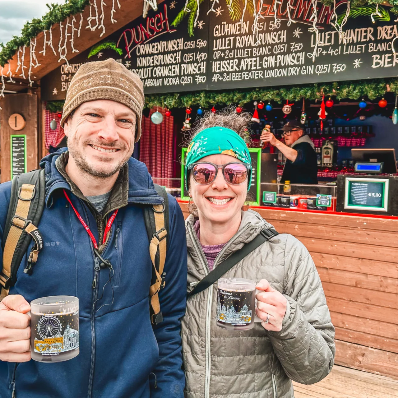 Deb & Tim in Vienna, Austria drinking gluhwein at a Christmas Market